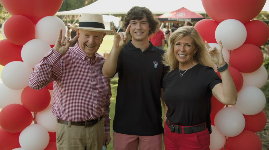 A family posing with their wolfies at the 2021 Legacy Luncheon.