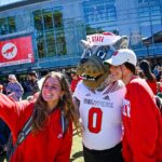 Students take a selfie with Mr. Wuf outside Talley Student Union.