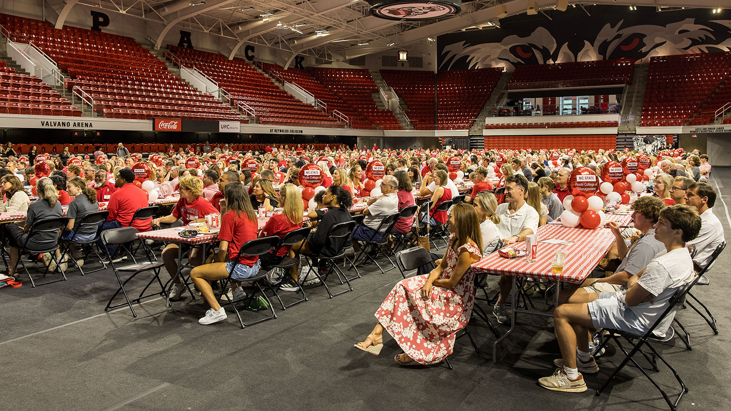 A large group of NC State alumni and friends gather for the Legacy Luncheon in Reynolds Coliseum.