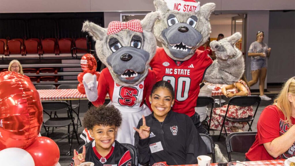 Members of the Pack throw up their Wolfies with Mr. and Ms. Wuf at the 2024 Legacy Luncheon.