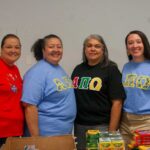 Four NC State Native American Alumni Network members gather for a photo.